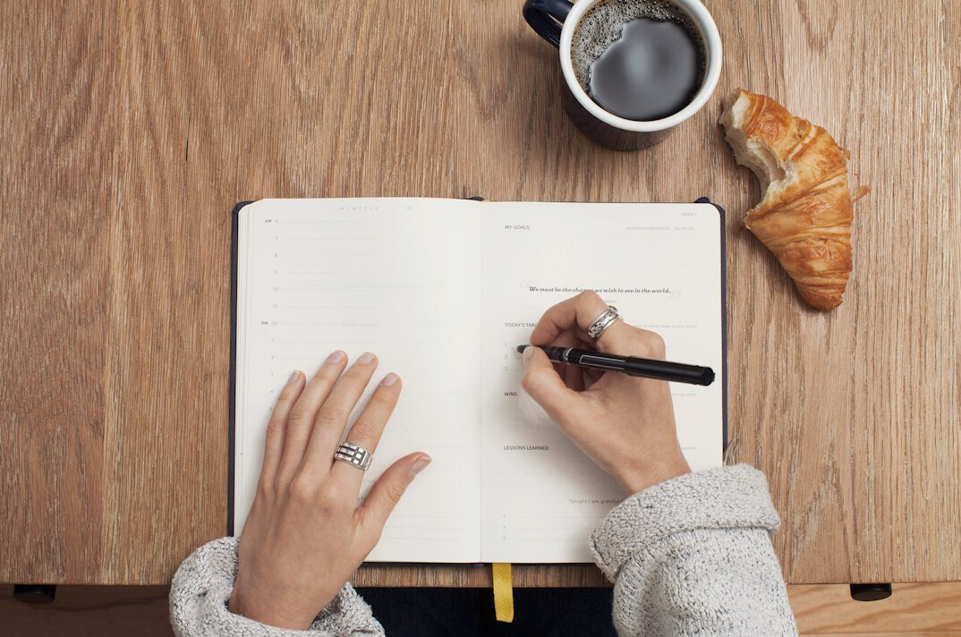woman writing in planner
