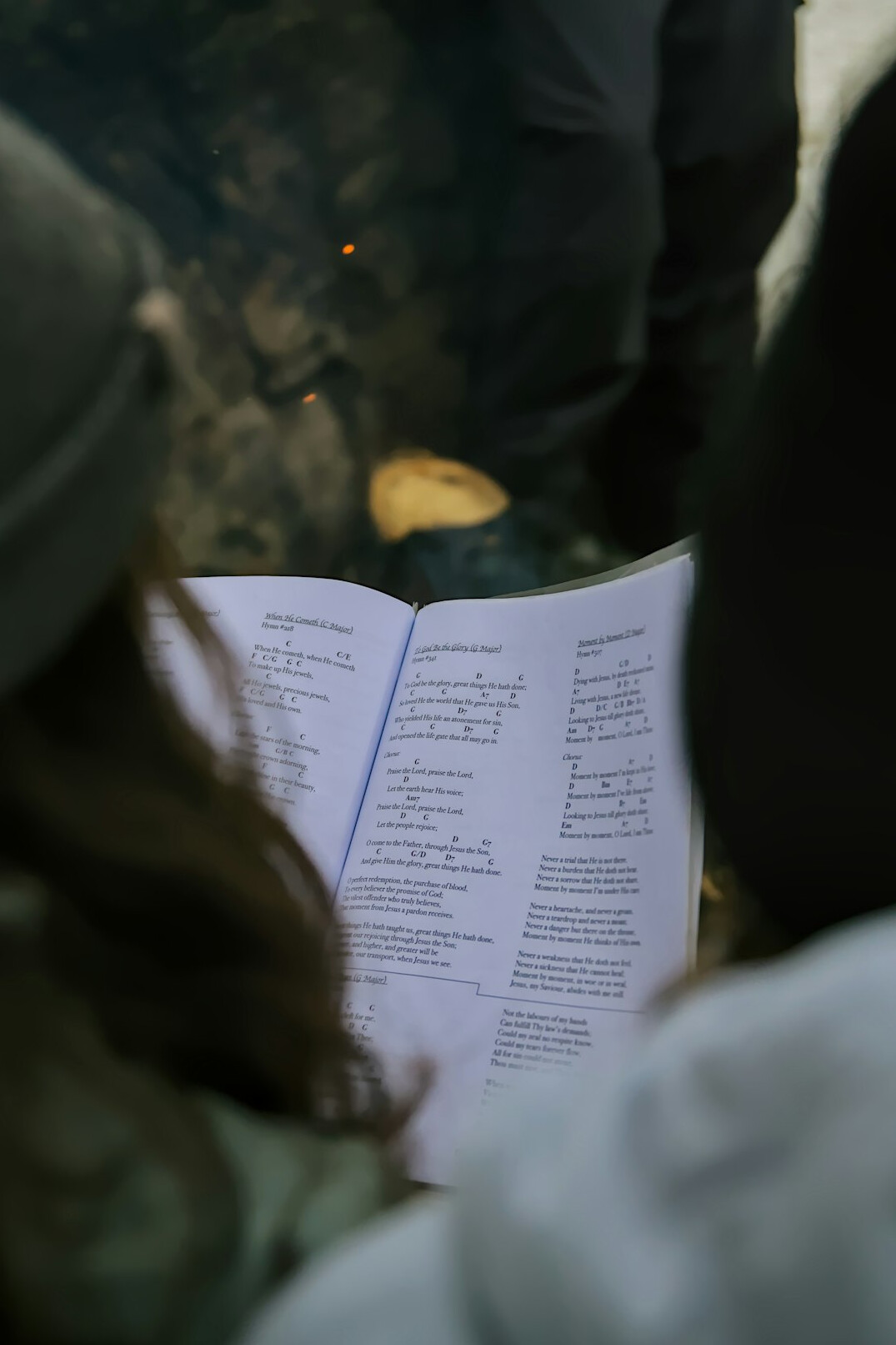 person reading book in nature
